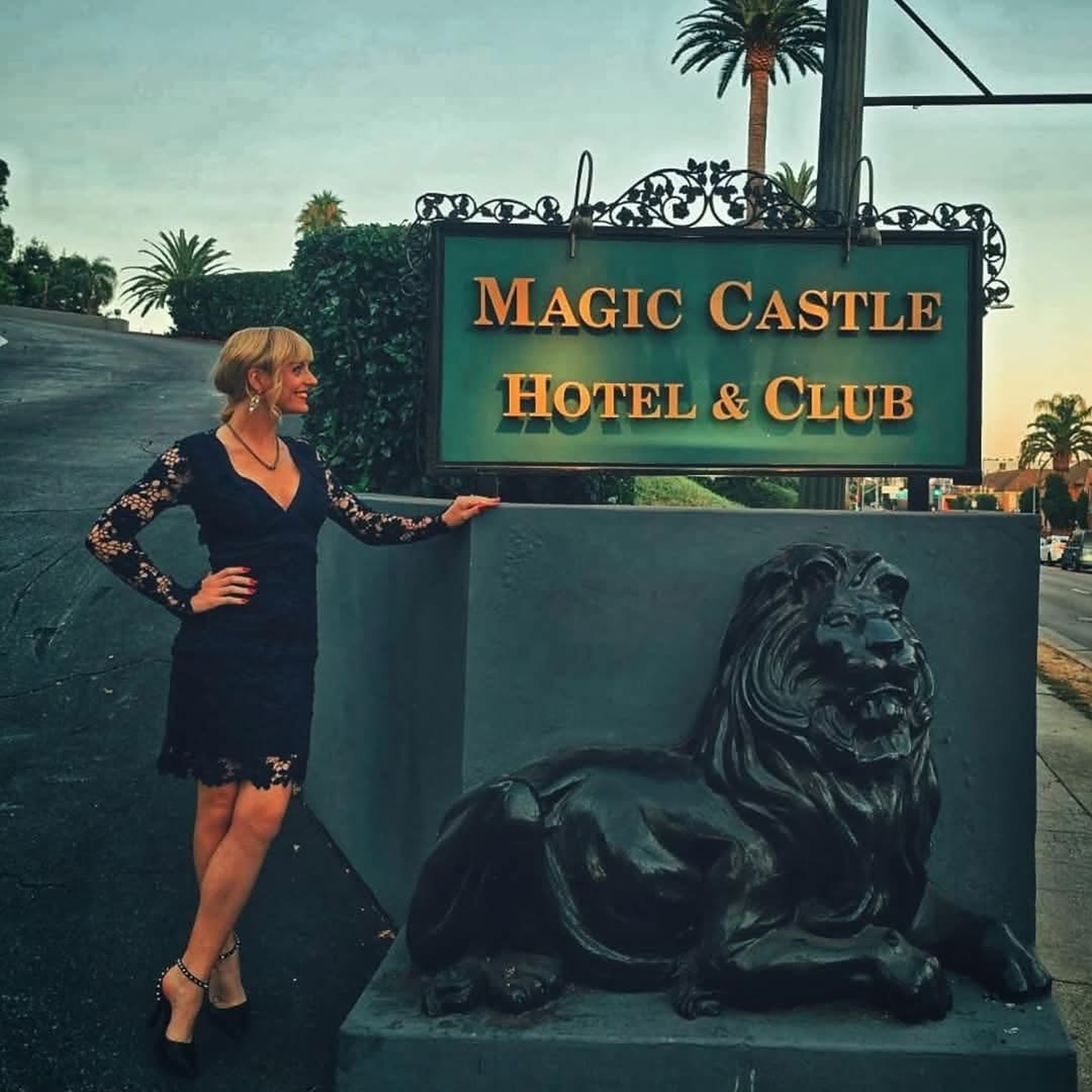 Natasha Lamb smiling beside the Magic Castle Hotel & Club sign
