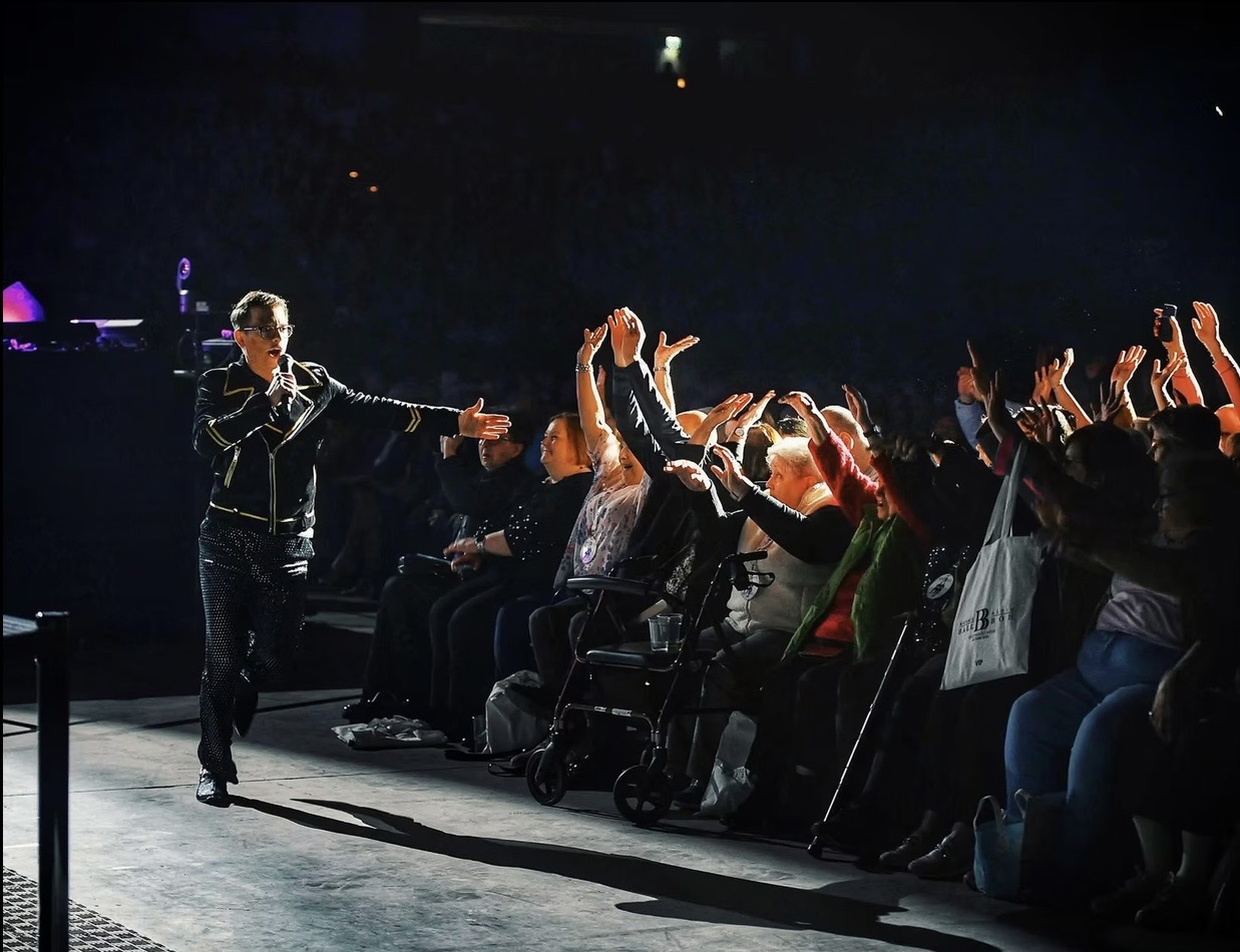 Matthew Pomeroy greeting an applauding theatre audience