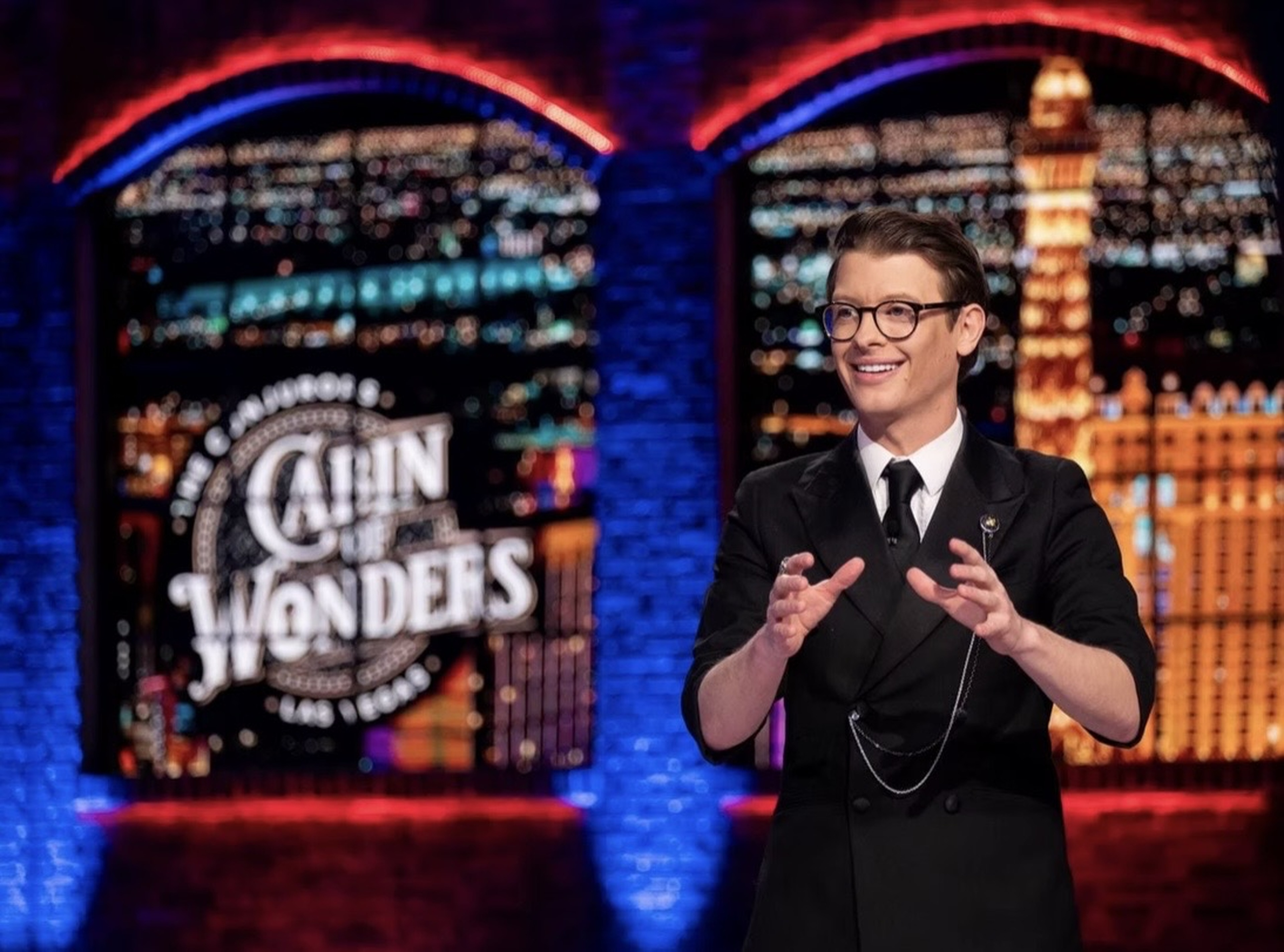 Matthew Pomeroy performing in front of the Cabin of Wonders stage backdrop